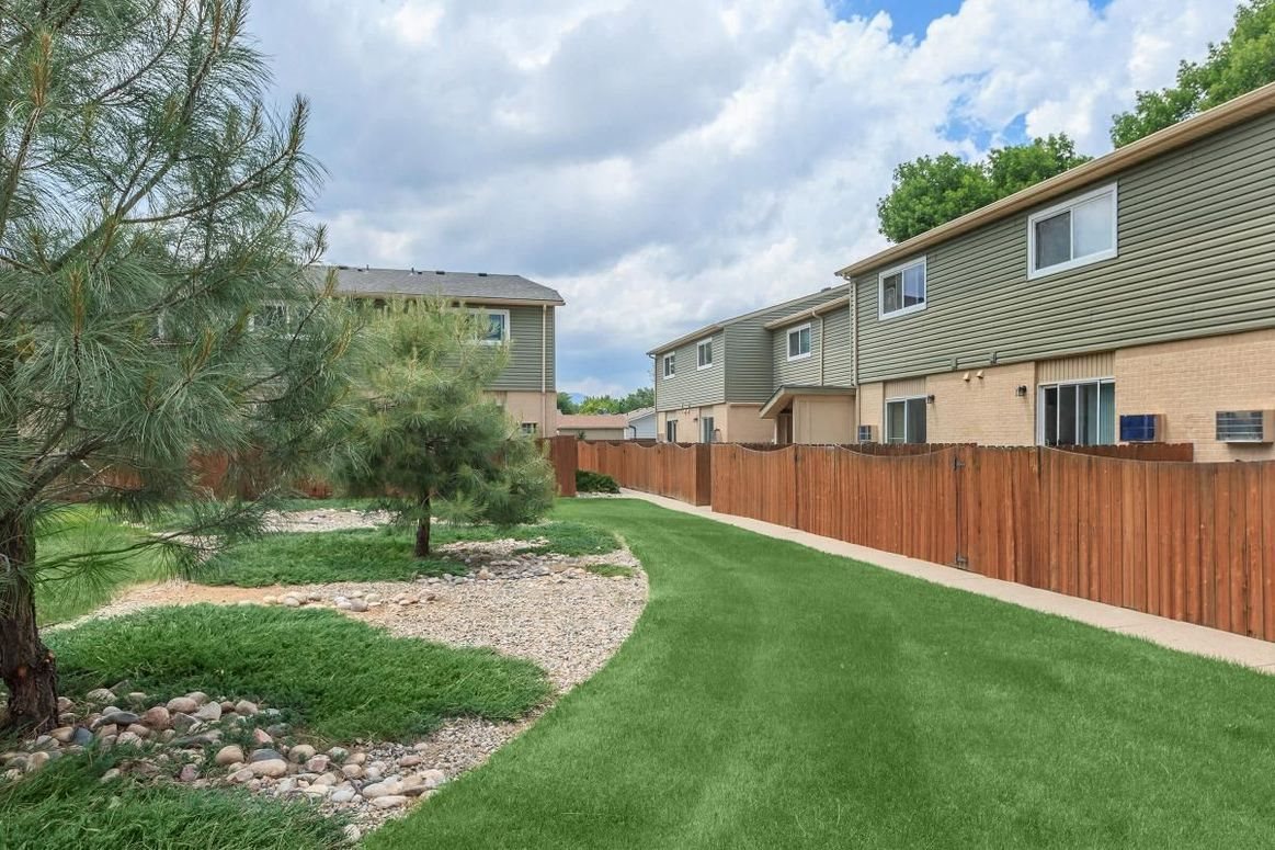 Alder Square property exterior grounds with patio fences Alder Square property exterior grounds with patio fences
