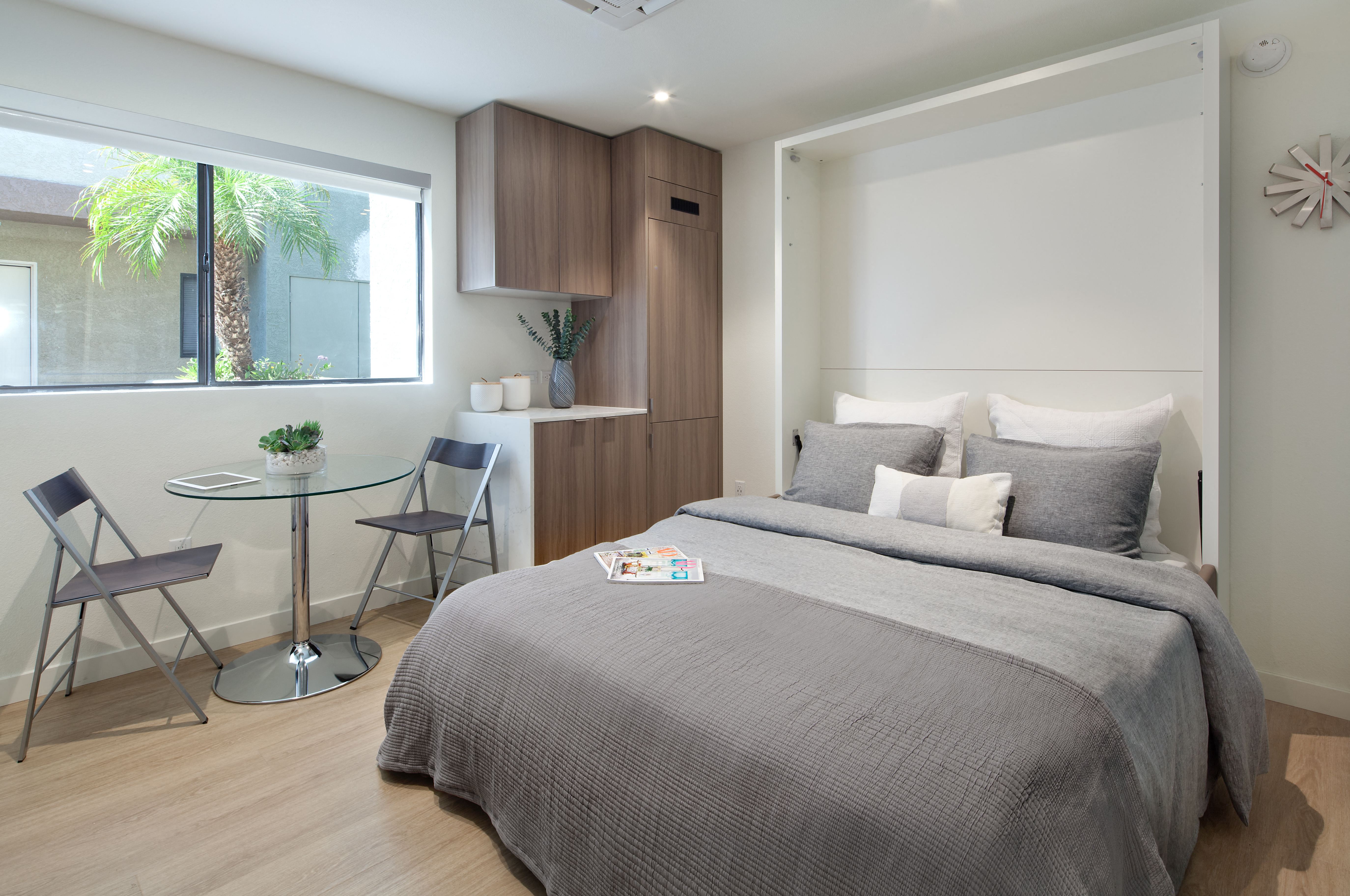 a bedroom with a bed and desk in a 555 waverly unit