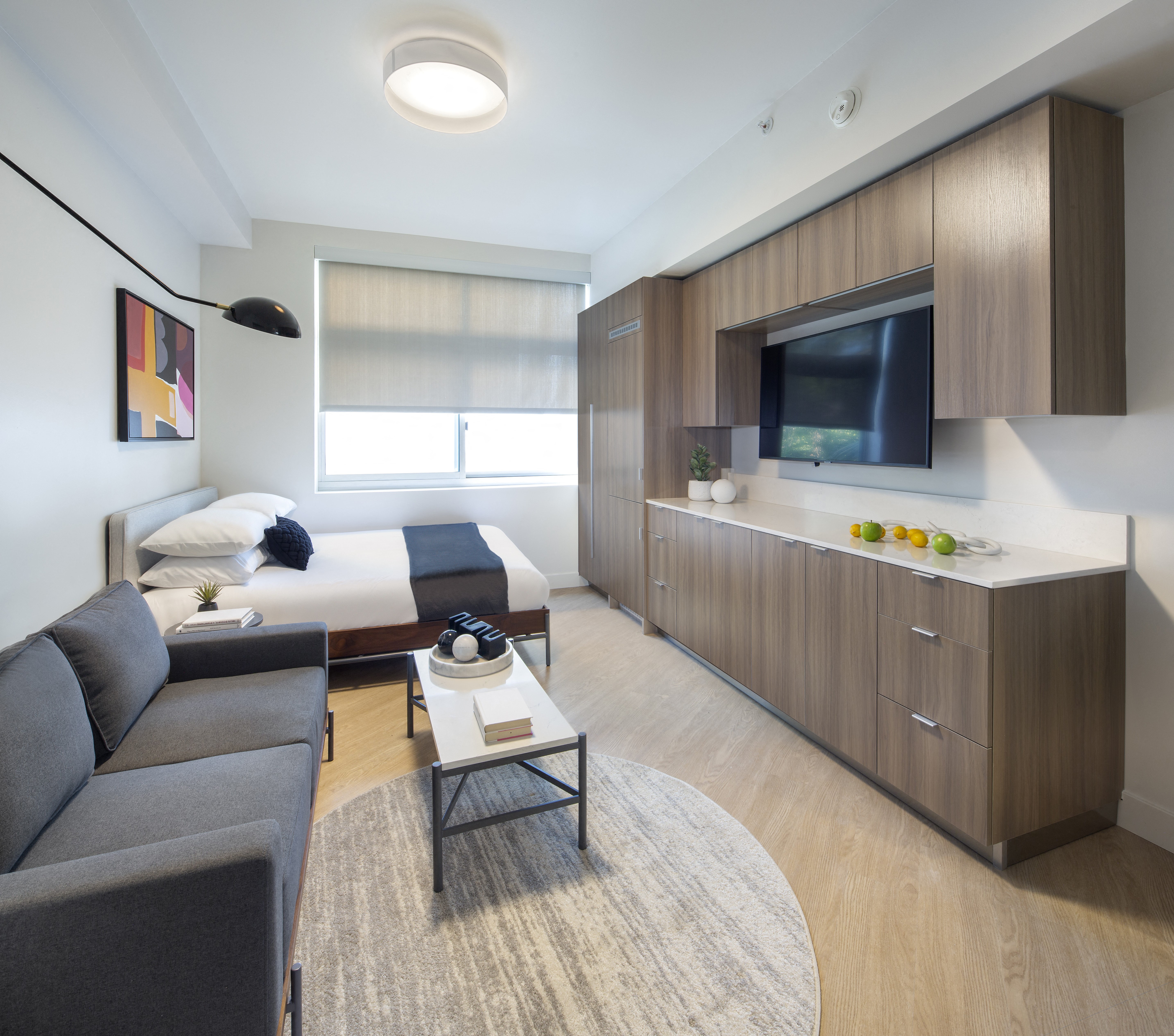 a modern kitchen with stainless steel appliances and wooden cabinets