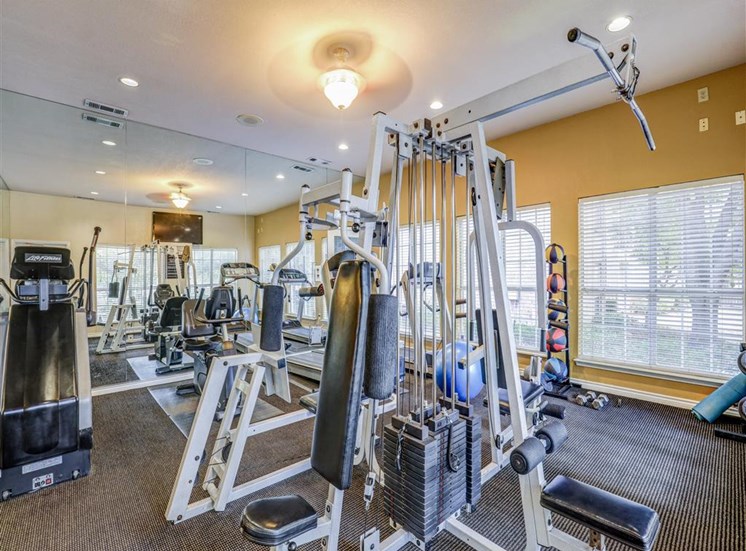 Fitness center Gym at Trinity Square Apartments in North Dallas, TX, For Rent. Now leasing 1 and 2 bedroom apartments.