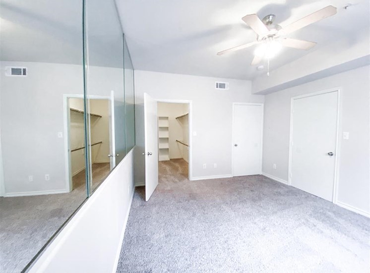 Spacious bedroom with walk in closet at Tuscany Square Apartments in North Dallas, TX, For Rent. Now leasing Studio, 1 and 2 bedroom apartments.