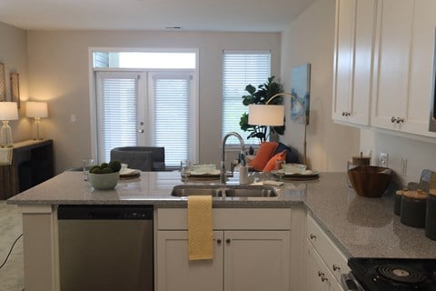 1 bedroom decorated model kitchen with view of living room