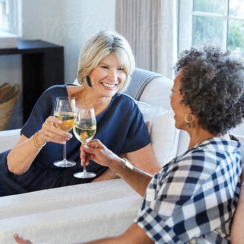 Women sharing a glass of white wine