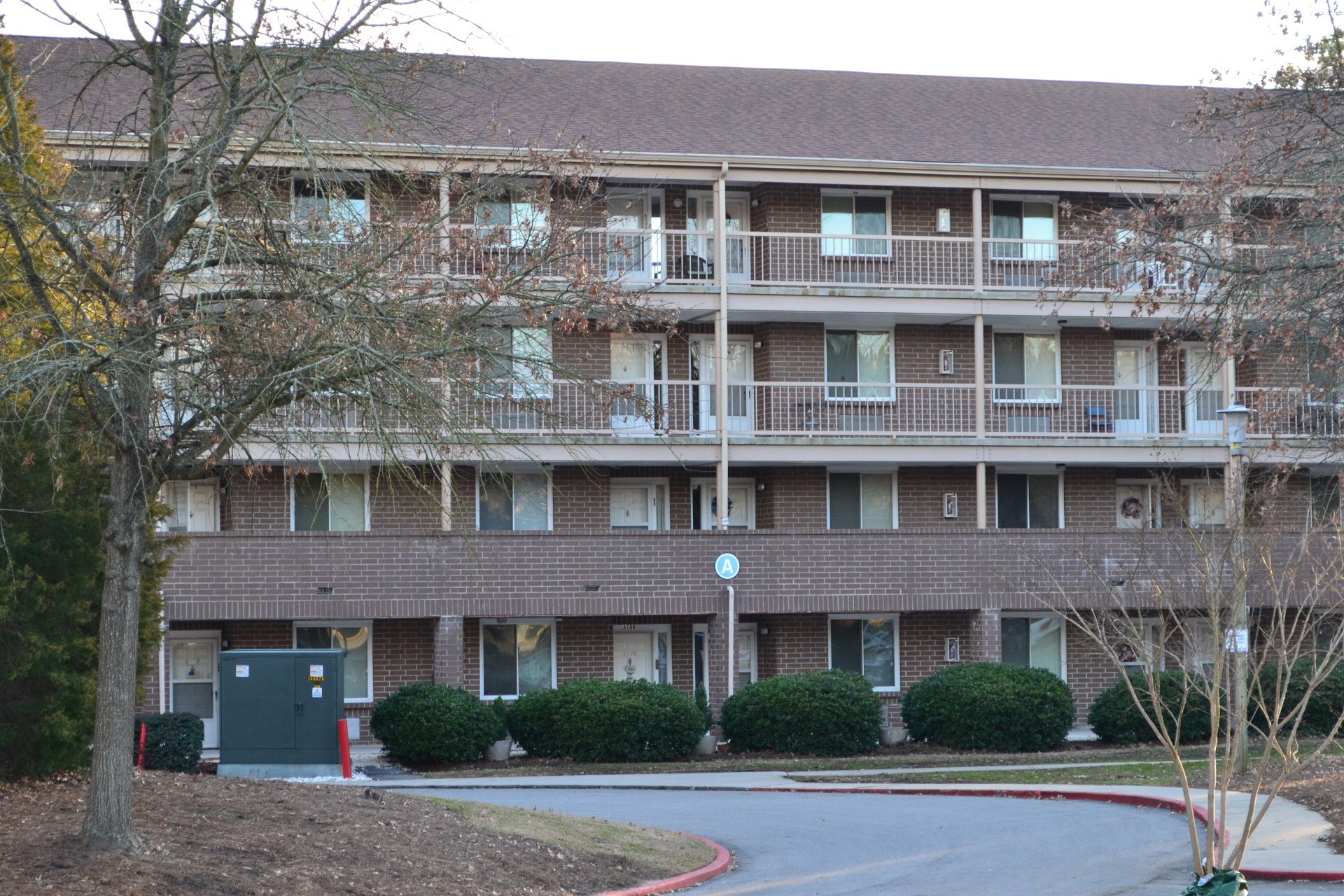 an exterior view of a building with a street in front of it