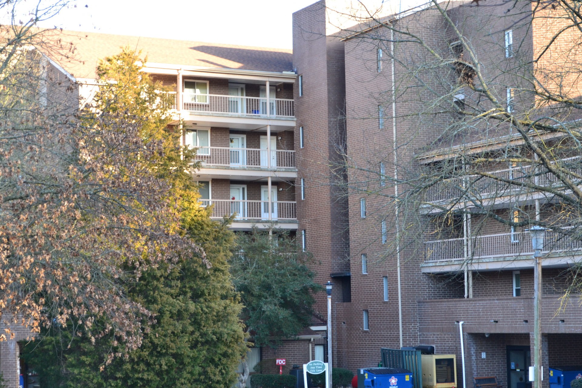 an apartment building with trees in front of it