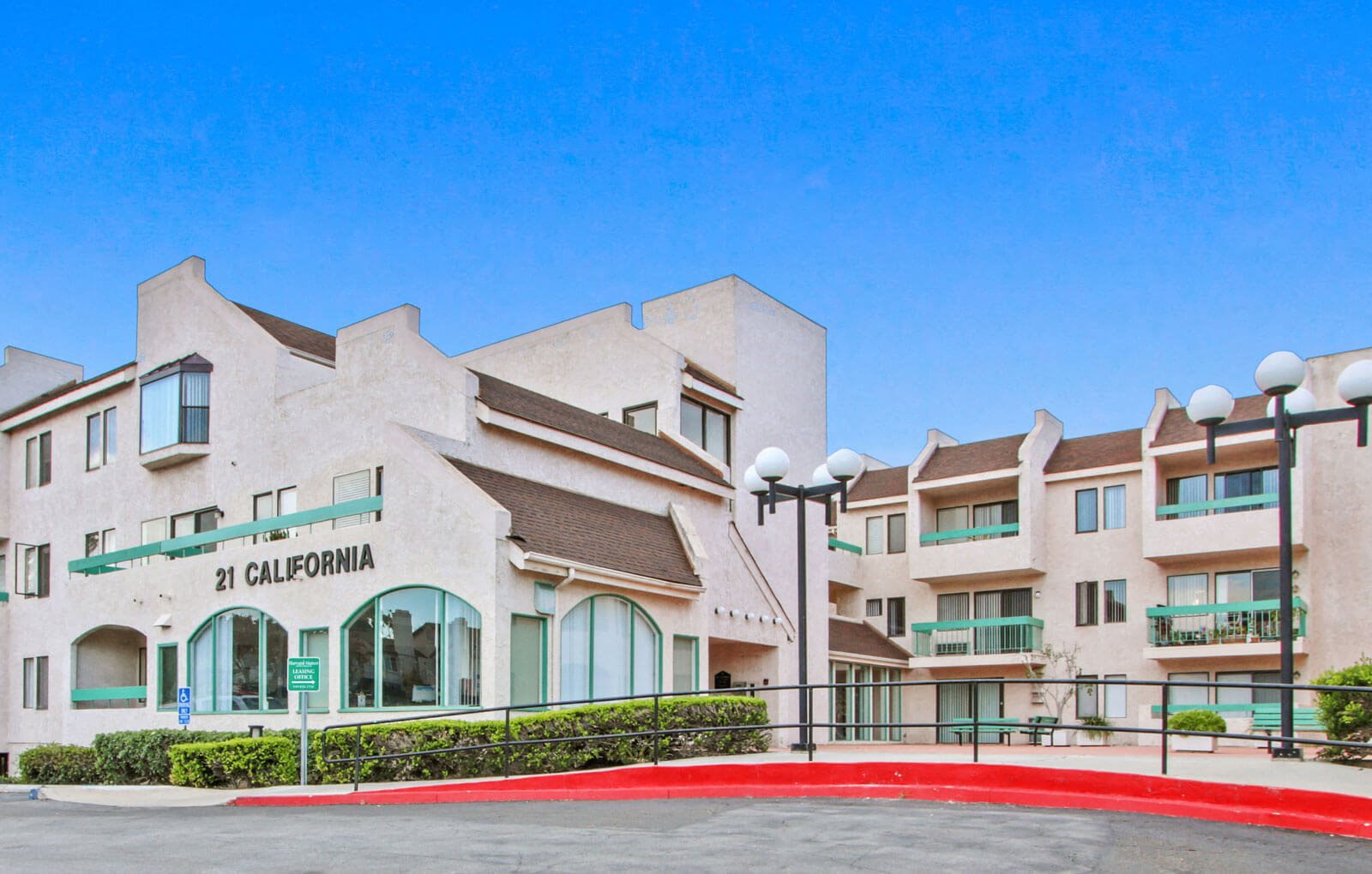 a large white building with a red circle in front of it