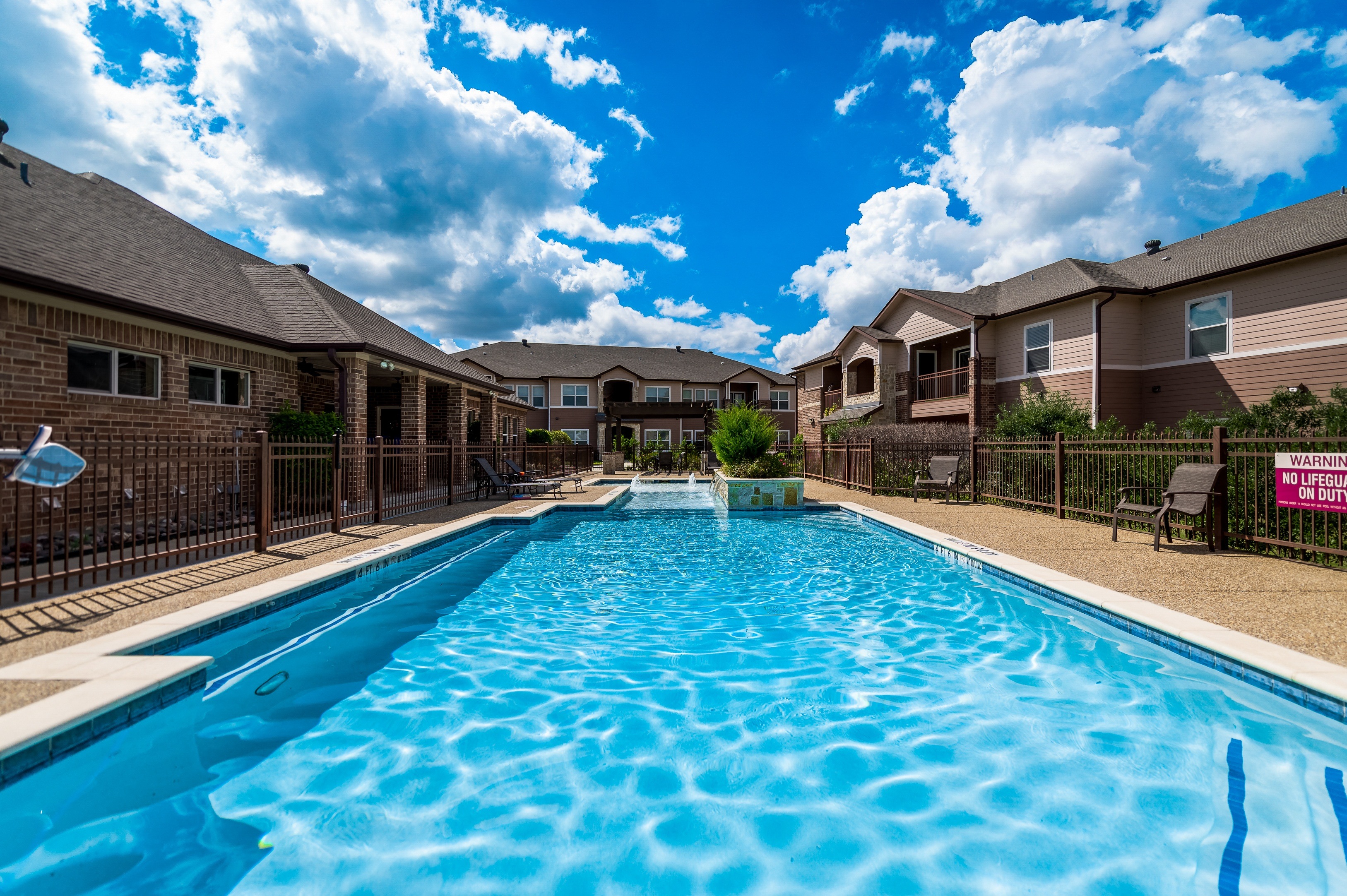 Swimming pool and grounds at Timber Creek Apartments in Sulphur Springs, TX