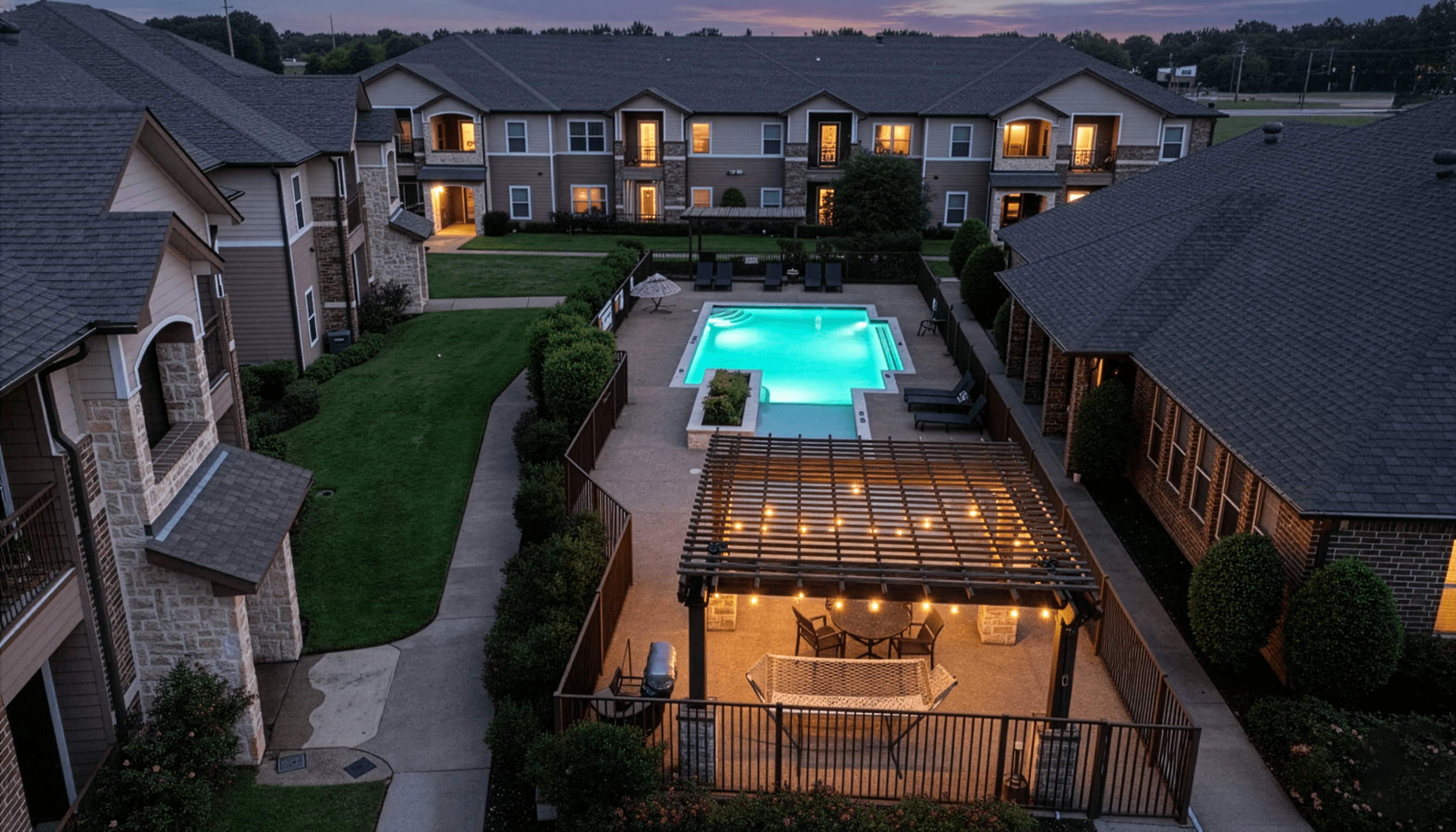 A swimming pool in a backyard surrounded by houses.