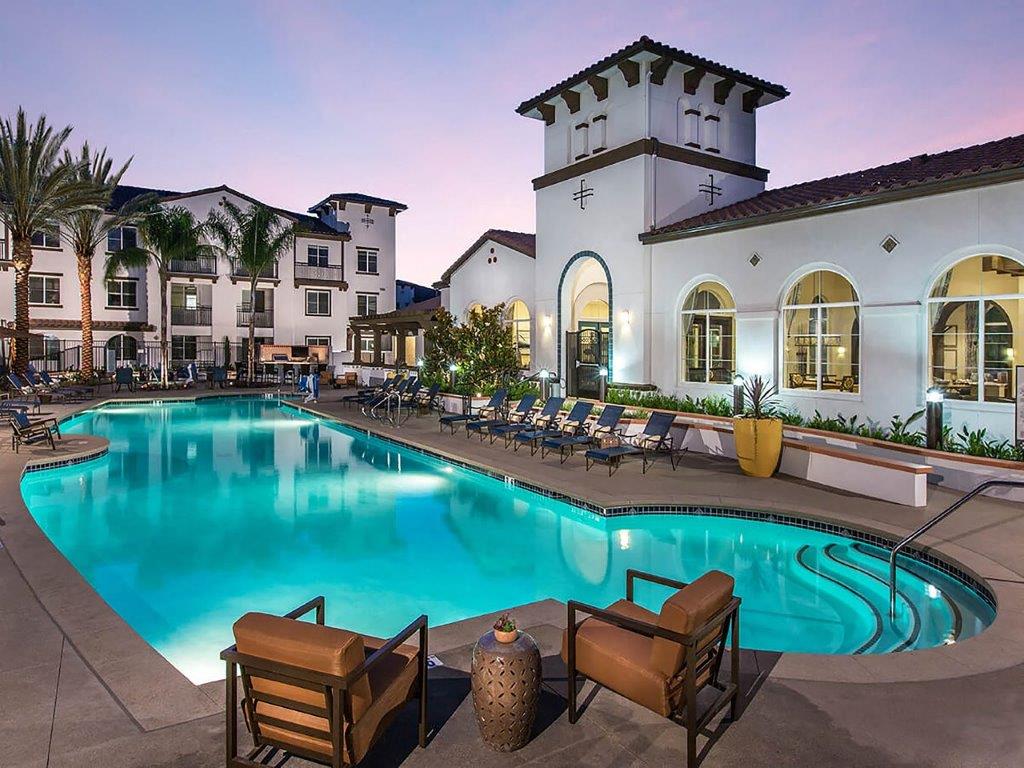 a large swimming pool in front of a building