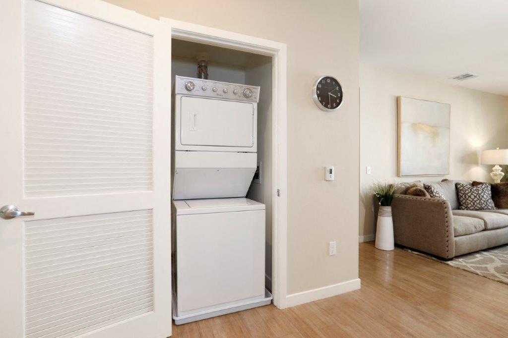 a white washer and dryer in a room with a couch