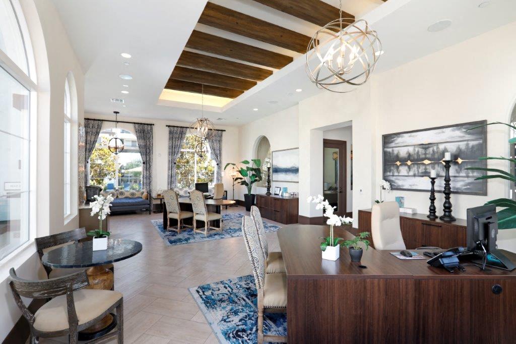 Professional leasing center at Vistara Apartments featuring a sleek table and comfortable seating area for meetings and consultations.