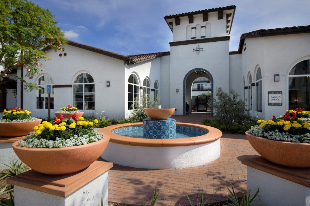 Elegant leasing office entry with a serene courtyard and fountain, creating a welcoming first impression for potential residents at Vistara Apartments.