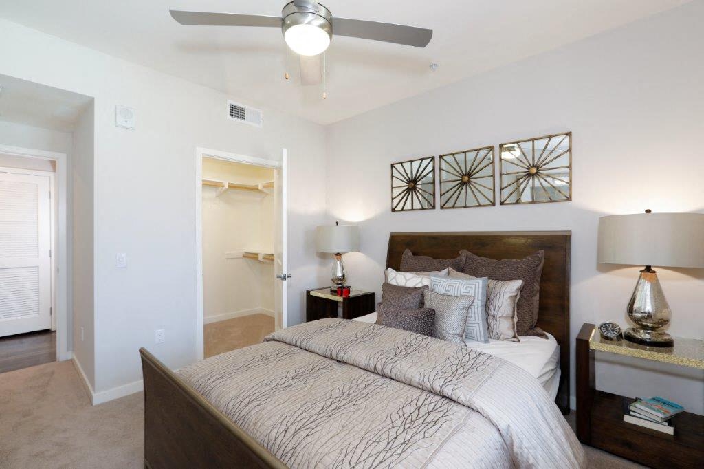 a bedroom with a bed and a ceiling fan