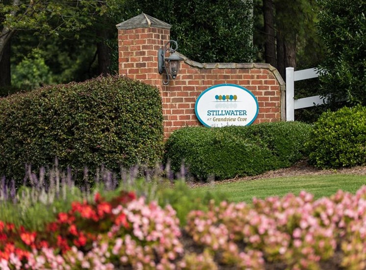 Entrance signage with flowers and bushes at Stillwater at Grandview Cove, Simpsonville, South Carolina