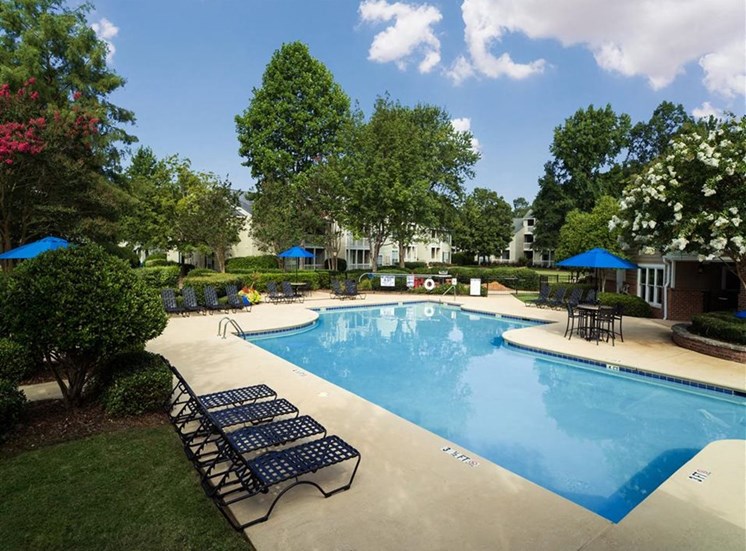 Large swimming pool and sundeck with lush landscaping all around at Stillwater at Grandview Cove, Simpsonville, 29680