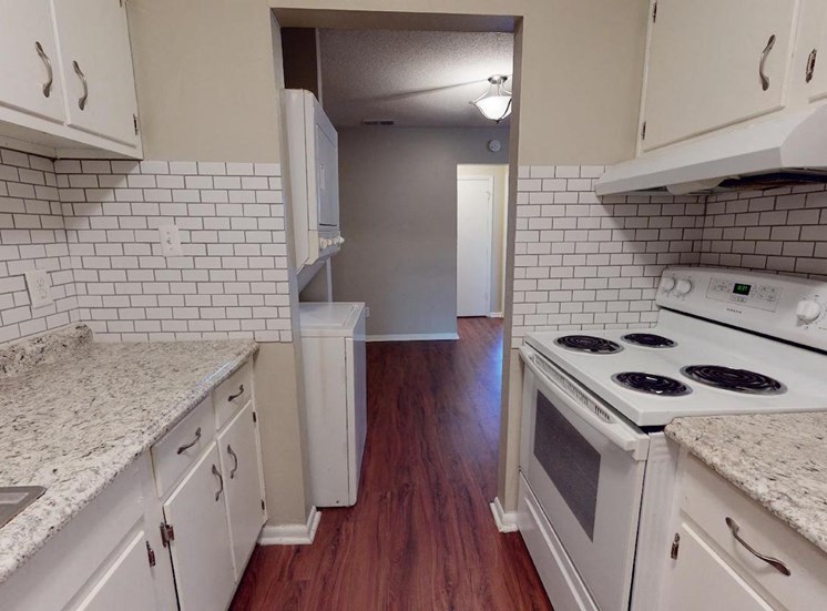 kitchen with white appliances, subway tile backsplash, and white cabinets