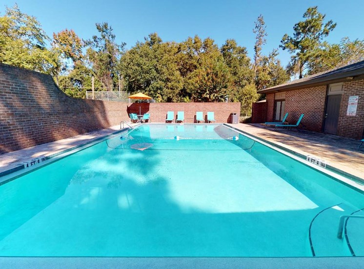 Swimming pool with lounge chairs at Aspen Run and Aspen Run II Apartments, Tallahassee, FL, 32304
