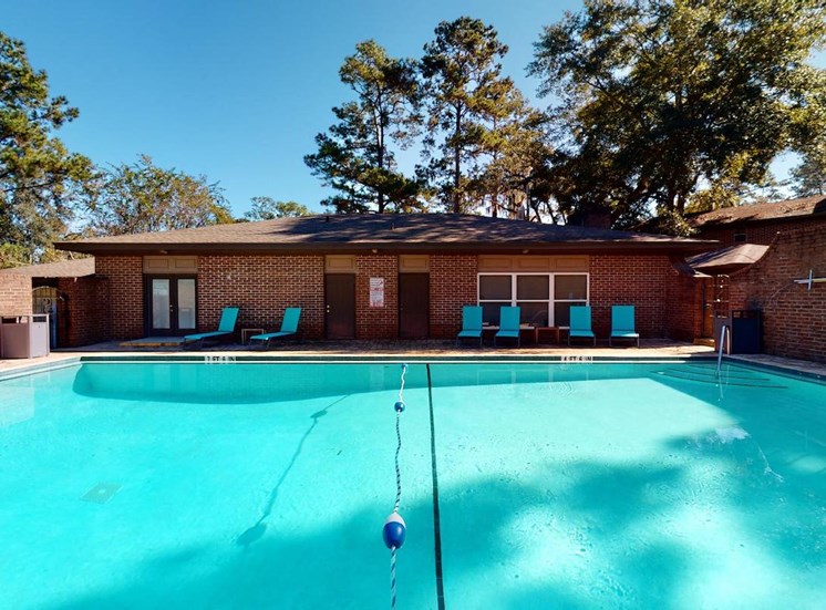 Swimming pool with lounge chairs beside the leasing office at Aspen Run and Aspen Run II Apartments, Florida, 32304