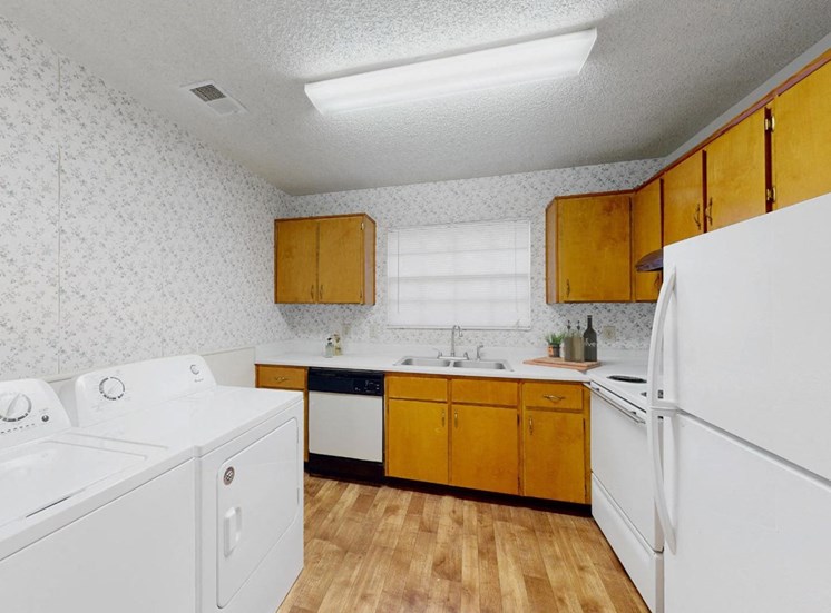kitchen with washer and dryer, white appliances, and ample cabinetry