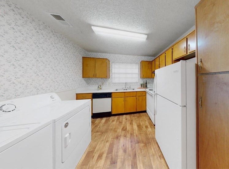 kitchen with ample cabinetry, white appliances, and washer and dryer