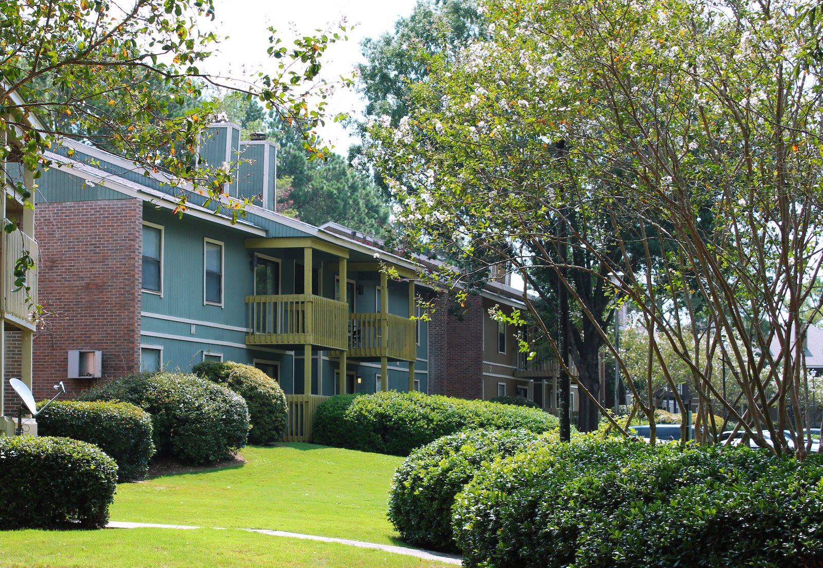 Exterior of apartment buildings with lush landscaping