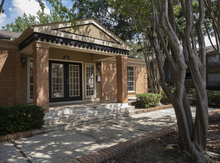 clubhouse with tall crepe myrtles and neat sidewalk at Hampton House