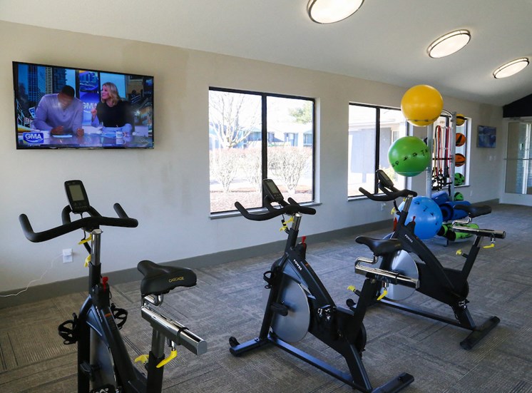 fitness center with TV and spin bikes