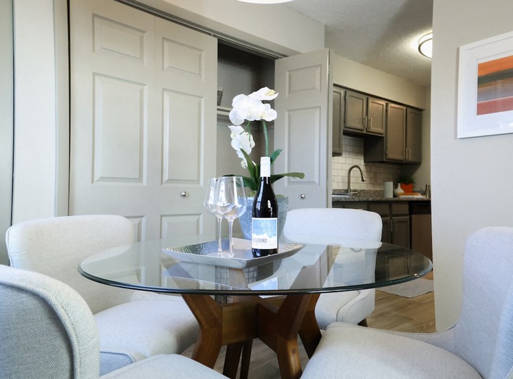 dining area beside utility closet and kitchen with table and chairs at The Whitney Franklin, Franklin, TN, 37064