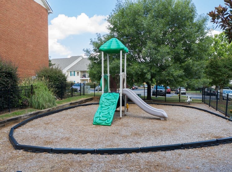 Fenced playground at The Point at Fairview Apartments in Prattville, AL