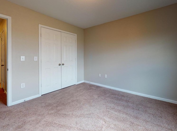 large bedroom with plush carpet and double closet