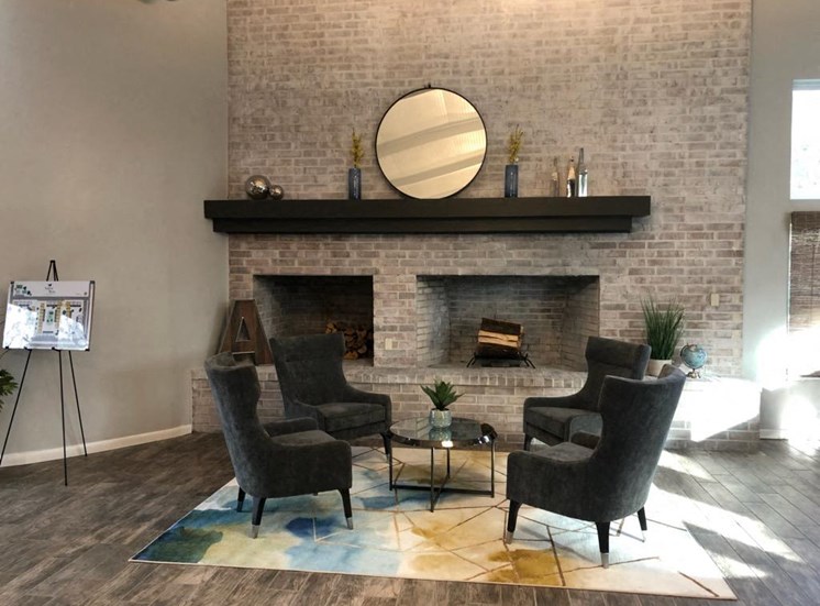 large fireplace with arm chairs in aspen run clubhouse
