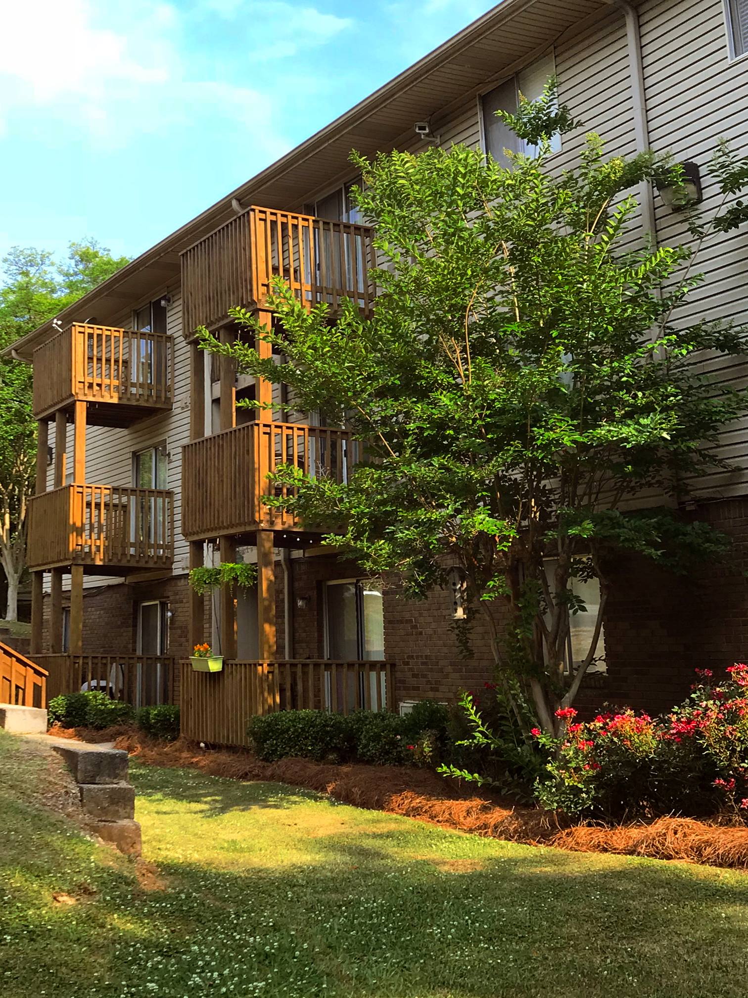 large crepe myrtle trees, flowers, and private patio and balconies