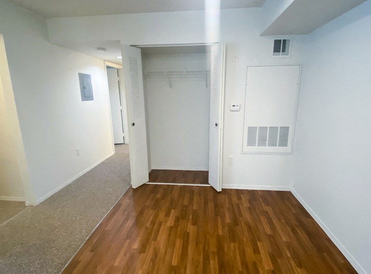 Dining Room with wood floors, white walls, and coat closet
