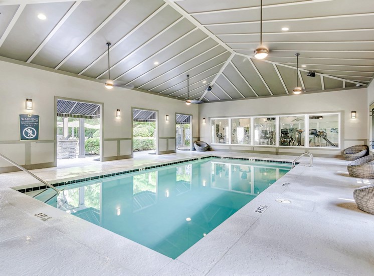 indoor pool with lounge chairs