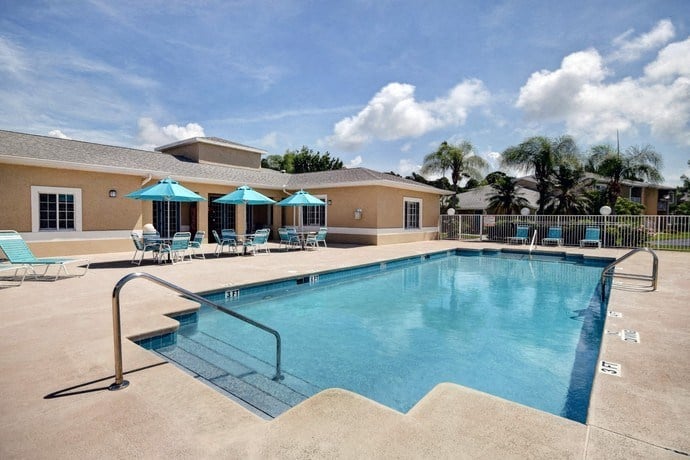Pool Side Relaxing Area With Sundeck at River Park Place Apartments, Vero Beach, Florida