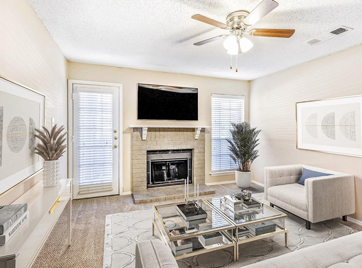 Living room with white doors, and spacious layout with ceiling fan