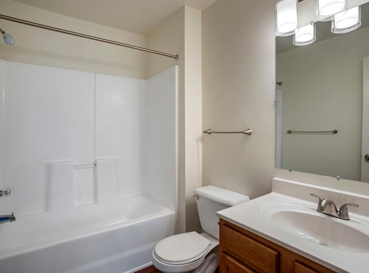 Bathroom with mirror above sink and towel rack.