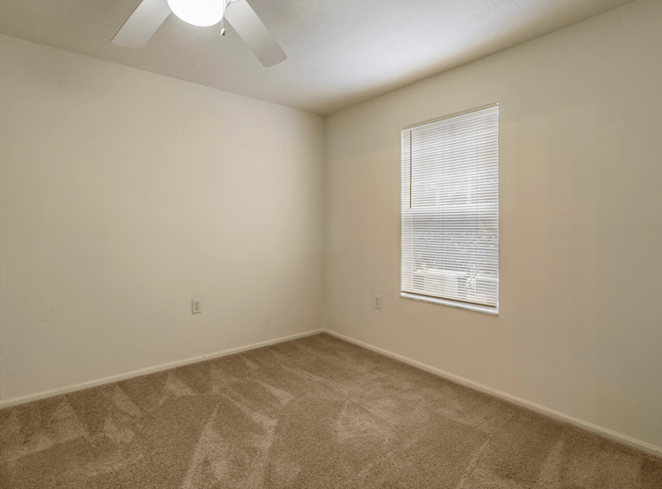 Bedroom with carpet flooring, multi speed ceiling fan, and window for natural lighting