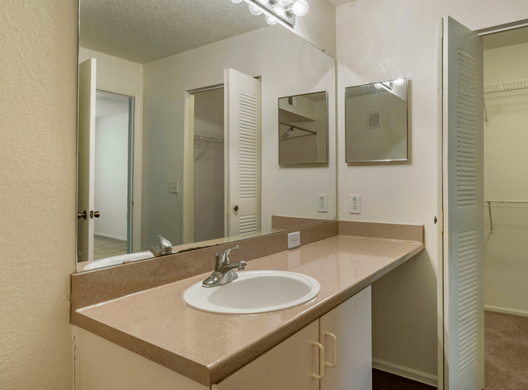 Bathroom with large mirror and vanity lighting