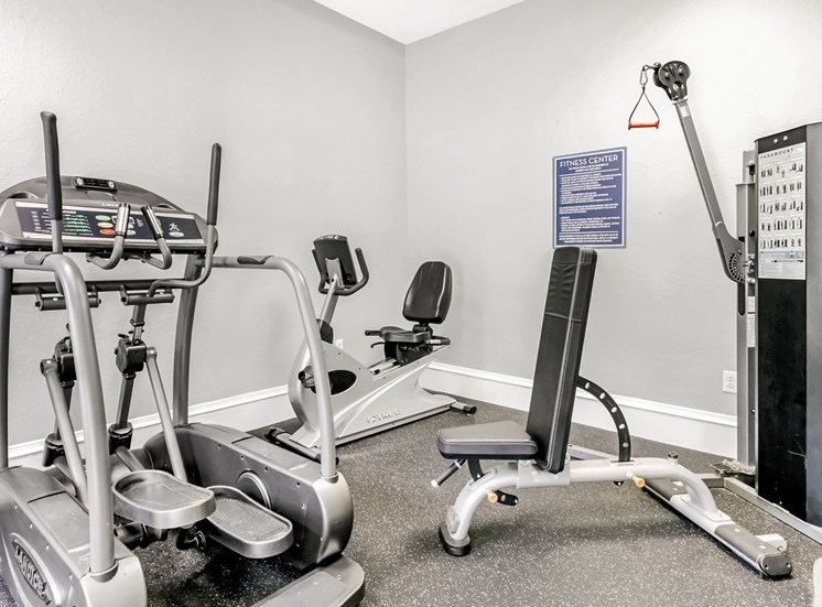 Fitness center with cardio and strength training machines.