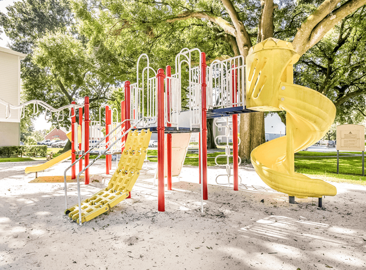 Playground with multiple slides, monkey bars and surrounding native landscape