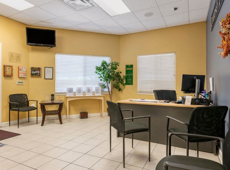 Leasing office with tiled flooring and wall mounted television