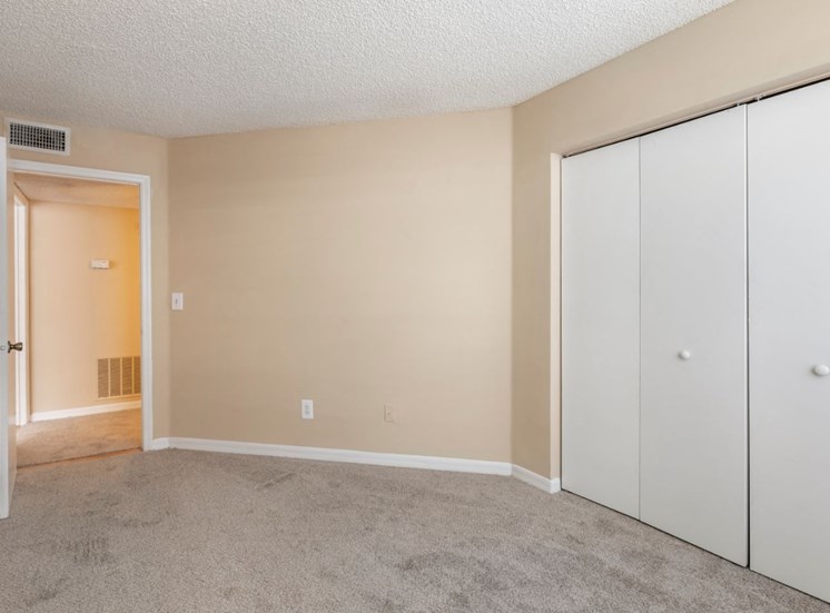 Bedroom with carpet flooring and large reach-in closet
