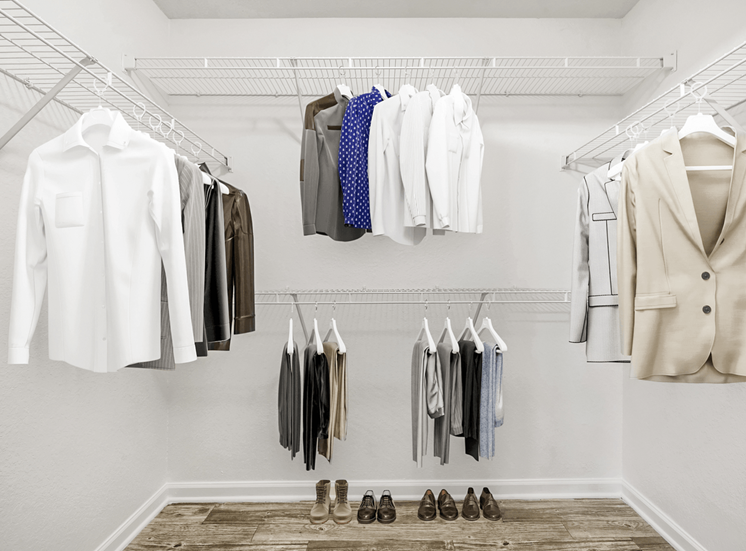 Virtually staged walk-in closet with carpet flooring