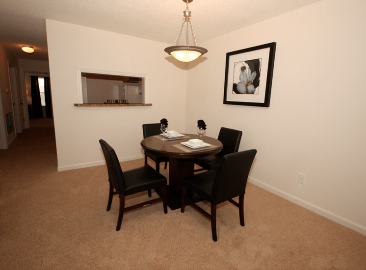 Dining room with carpet flooring and pendant lighting
