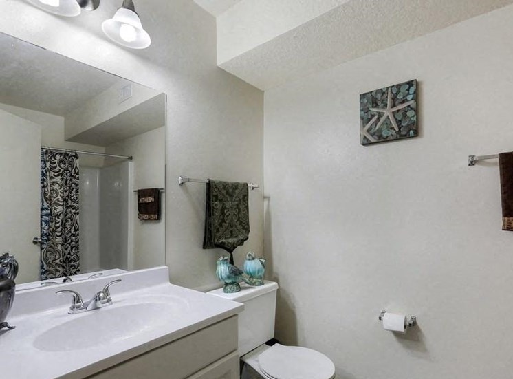 Model bathroom with white countertop and cabinets