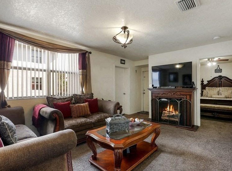 Model living room with couch and fireplace