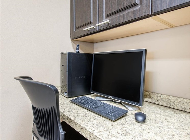 Business Center with Desktop Computer on Tan Counter Under Brown Cabinets