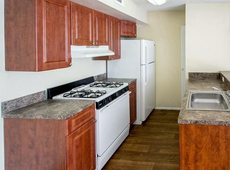 Kitchen with gas stove and white appliances