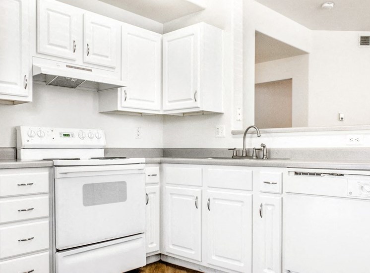 Fully Equipped Kitchen with White Appliances, Grey Counters and White Counters